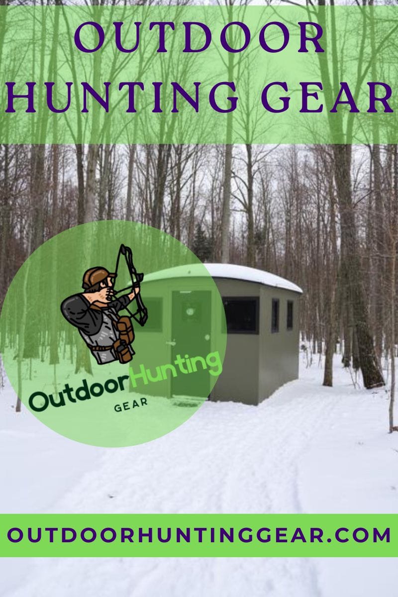 Hunter in fiberglass deer blinds, looking through the sight for game.